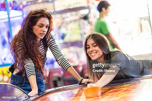 group of friends at the amusement arcade - girls ice hockey stock pictures, royalty-free photos & images