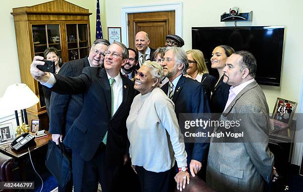 Bob Goodlatte takes a photo during a meeting with Dionne Warwick, Neil Portnow;Booker T. Jones and other members of the Recording Academy during...