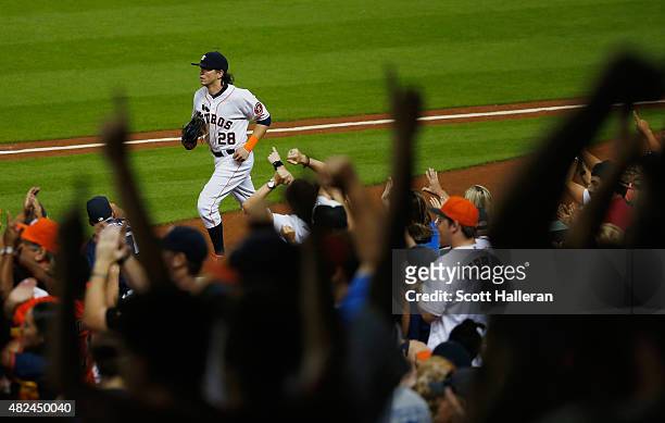Fans cheer after Colby Rasmus of the Houston Astros made a play in right field in the sixth inning against the Los Angeles Angels of Anaheim during...