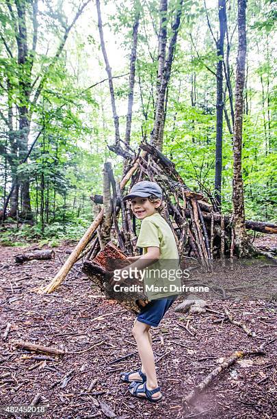 kid building a shack in forest - hut stock pictures, royalty-free photos & images