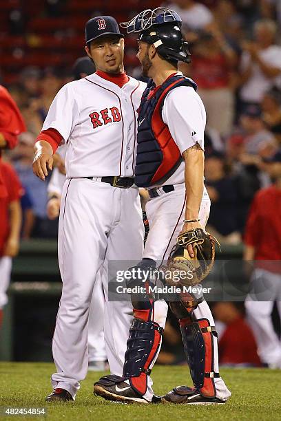 Junichi Tazawa of the Boston Red Sox and Blake Swihart celebrate at the end of the ninth inning against the Chicago White Sox at Fenway Park on July...