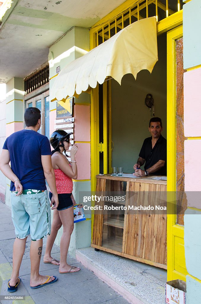 Incipient market economy in Cuba: A man and woman take a...