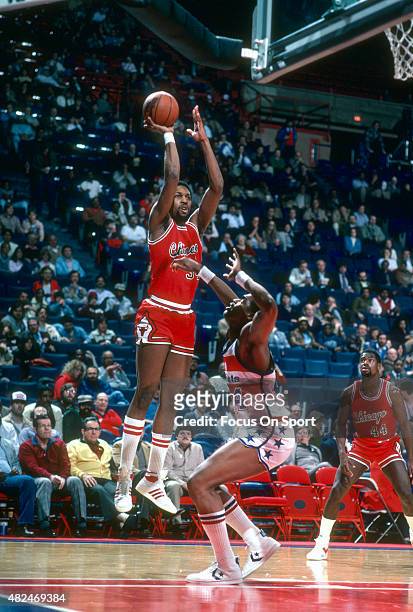 David Greenwood of the Chicago Bulls shoots over Rick Mahorn of the Washington Bullets during an NBA basketball game circa 1983 at the Capital Centre...