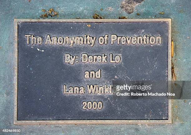 Plaque at the WSIB Simcoe park workers monument with the words The Anonymity of Prevention Derek Lo and Lana Winkler 2000. The Anonymity of...