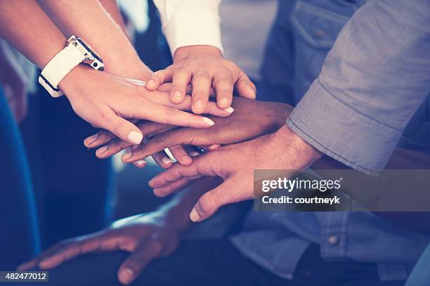 group of young multi cultural business people celebrating. - hand stack stock pictures, royalty-free photos & images