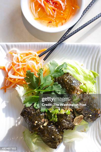 Marinated ground beef with minced garlic and chopped onions wrapped in grape leaves at Cam Ranh Bay Pho and Grill photographed in Wheaton, MD. .