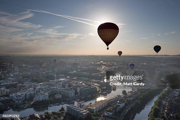 Balloons take to the skies at a preview flight to launch next week's Tribute Bristol International Balloon Fiesta on July 31, 2015 in Bristol,...
