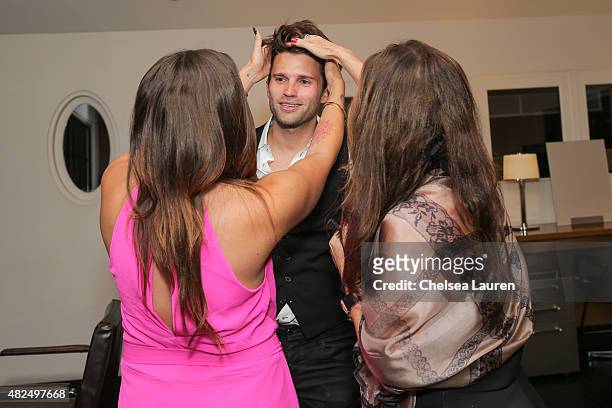 Personalities Katie Maloney and Lisa Vanderpump cut Tom Schwartz's hair at Katie's Pucker and Pout launch party at Frederic Fekkai Hair Salon on July...