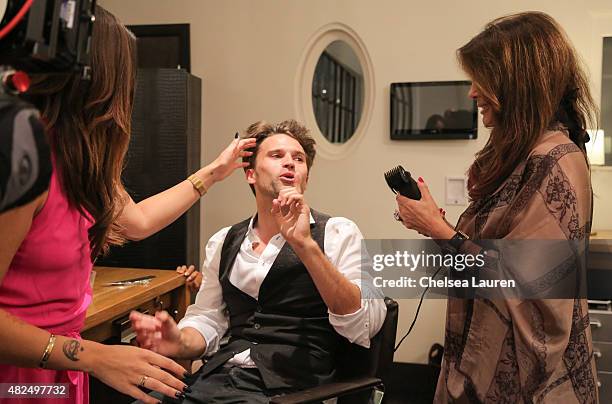 Personalities Katie Maloney and Lisa Vanderpump cut Tom Schwartz's hair at Katie's Pucker and Pout launch party at Frederic Fekkai Hair Salon on July...