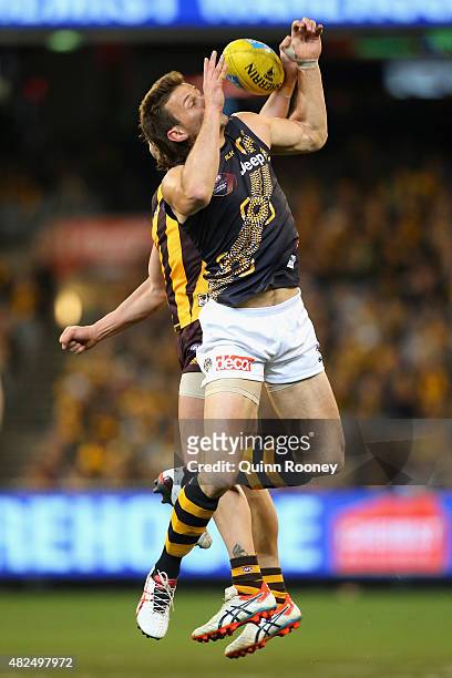 Ivan Maric of the Tigers attempts to mark infront of Jordan Lewis of the Hawks during the round 18 AFL match between the Hawthorn Hawks and the...