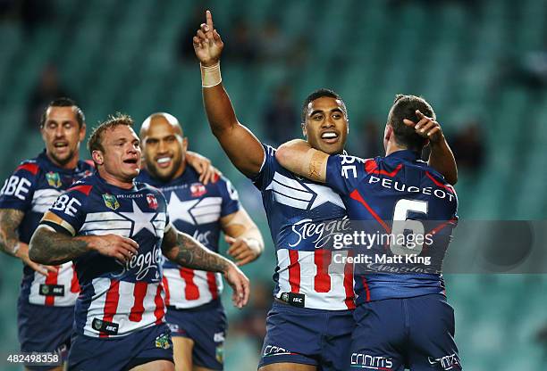 Michael Jennings of the Roosters celebrates with team mates after scoring a try during the round 21 NRL match between the Sydney Roosters and the...