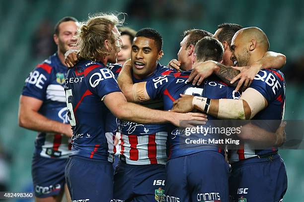 Michael Jennings of the Roosters celebrates with team mates after scoring a try during the round 21 NRL match between the Sydney Roosters and the...