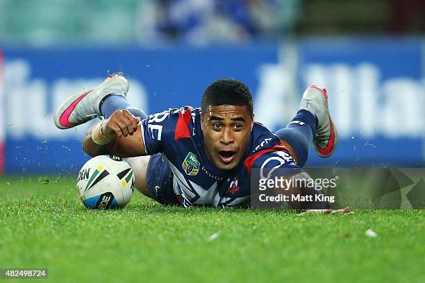 Michael Jennings of the Roosters dives over to score a try during the round 21 NRL match between the Sydney Roosters and the Canterbury Bulldogs at...