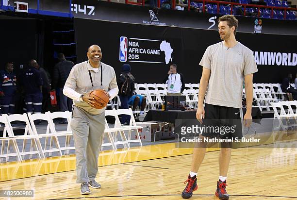 Head Coach Lionel Hollins of Team World smiles with Pau Gasol of Team World during practice for the NBA Africa Game 2015 as part of Basketball...