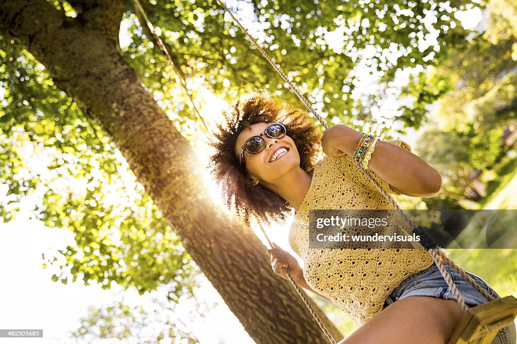 African american woman sitting on a swing