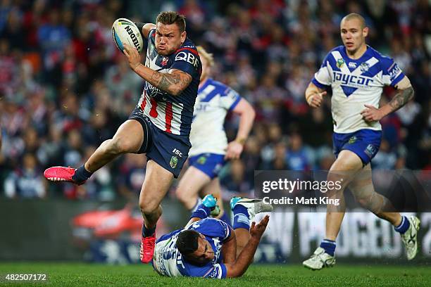 Jared Waerea-Hargreaves of the Roosters makes a break and beats the tackle of Lloyd Perrett of the Bulldogs during the round 21 NRL match between the...