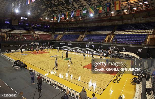 Basketball players warm up during a training session at the Ellis Park Johannesburg arena on the eve of the NBA Africa basket match on July 31, 2015...