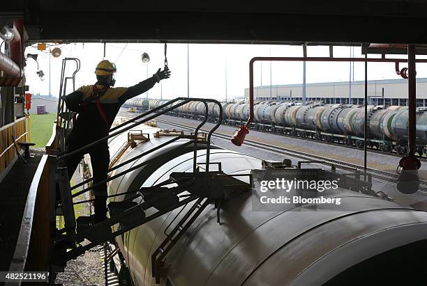 An employee accesses a freight wagon filled with petroleum fuel ahead of shipping at the "TANECO" refining and petrochemical plant, operated by...