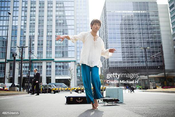 street performer dancing in the financial  area - street performer stock pictures, royalty-free photos & images