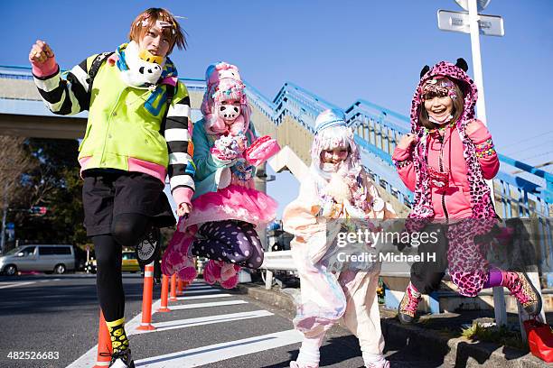 japanese teens jumping in harajuku, tokyo - harajuku fashion stock pictures, royalty-free photos & images