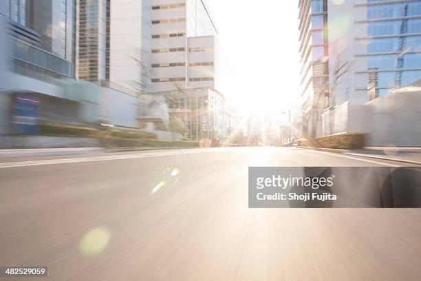 road in city with sunlight - brightly lit foto e immagini stock