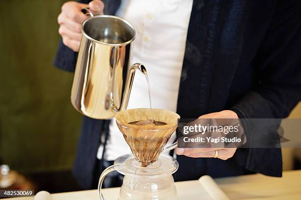 man has put a drip coffee at the counter - coffee filter stock pictures, royalty-free photos & images