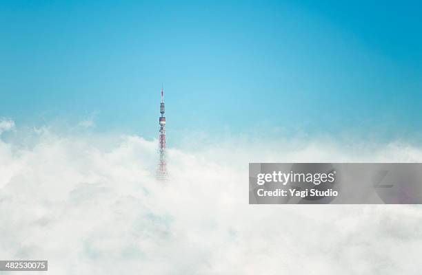 tower covering in clouds - pinnacle stock-fotos und bilder