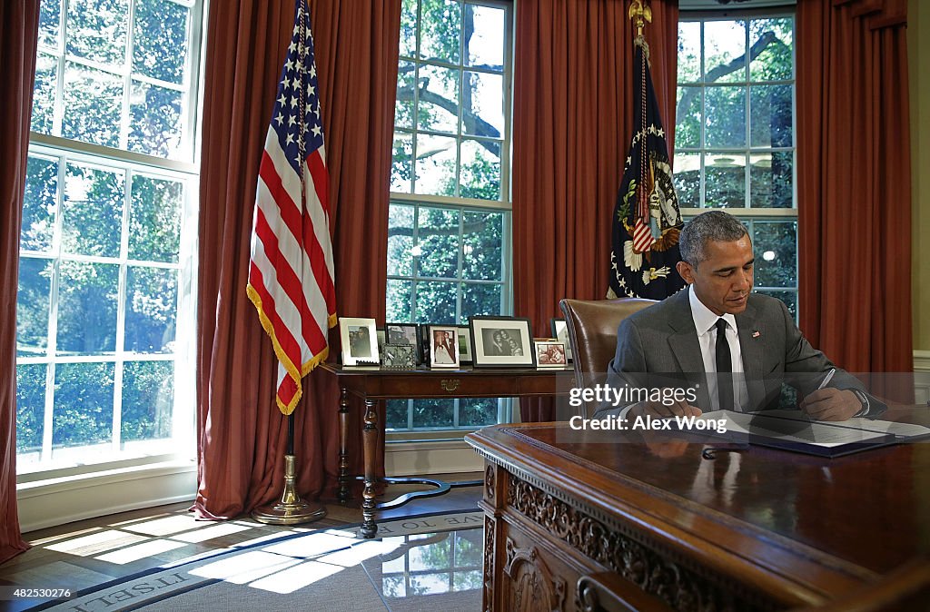 President Obama Signs Bill In Oval Office