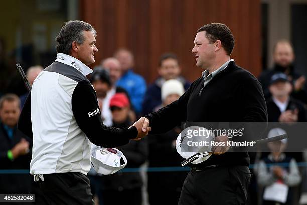 Chris Doak of Scotland is congratulated by Paul Lawrie of Scotland after their match during round 2 of the Saltire Energy Paul Lawrie Matchplay at...