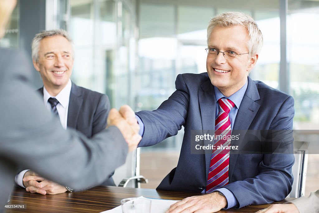 Shaking hands at a meeting