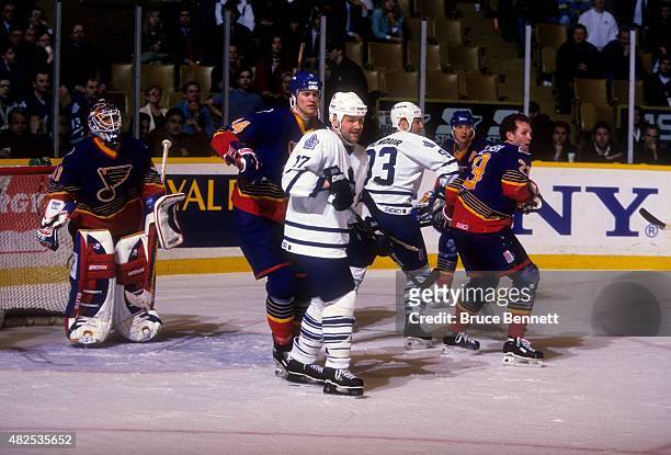 Wendel Clark and Doug Gilmour of the Toronto Maple Leafs battle with Chris Pronger, Craig MacTavish and goalie Grant Fuhr of the St. Louis Blues...
