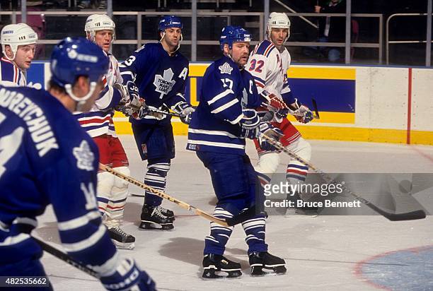 Wendel Clark and Doug Gilmour of the Toronto Maple Leafs wait for the shot as Brian Leetch and Stephane Matteau of the New York Rangers defend on...