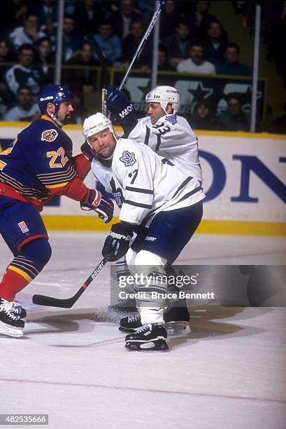 Wendel Clark and Doug Gilmour of the Toronto Maple Leafs skate against David Roberts of the St. Louis Blues during Game 5 of the 1996 Western...