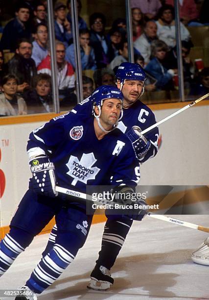 Doug Gilmour and Wendel Clark of the Toronto Maple Leafs skate on the ice during an NHL game in October, 1992 at the Maple Leaf Gardens in Toronto,...