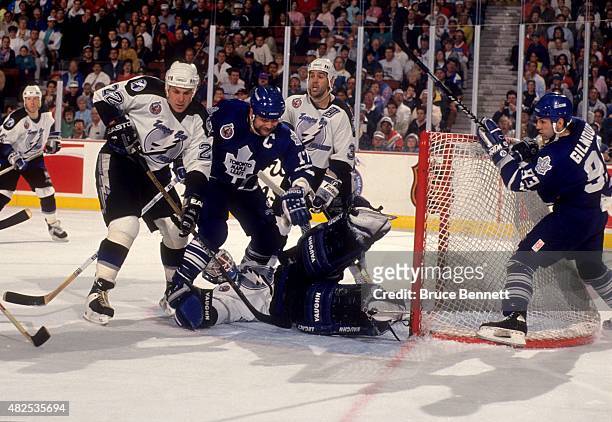 Wendel Clark and Doug Gilmour of the Toronto Maple Leafs try to score as Shawn Chambers, goalie Pat Jablonski and Peter Taglianetti of the Tampa Bay...