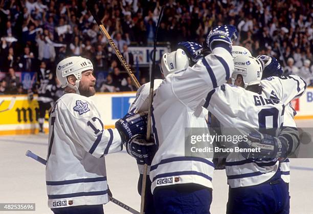 Wendel Clark, Bob Rouse and Doug Gilmour of the Toronto Maple Leafs celebrate a goal during a game in the Western Conference Finals against the Los...