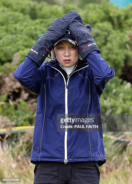 South Korea's Kim Hyo Joo warms her hands in mittens before playing her shot onto the 14th green as she plays in the second round of the Women's...