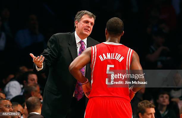Head coach Kevin McHale of the Houston Rockets ralks with Jordan Hamilton during a game against the Brooklyn Nets at Barclays Center on April 1, 2014...