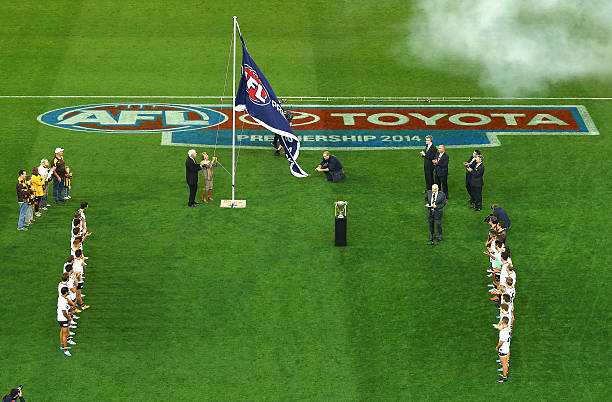 The 2013 Hawthorn premiership flag is unfurled to the crowd during the round three AFL match between the Hawthorn Hawks and the Fremantle Dockers at...