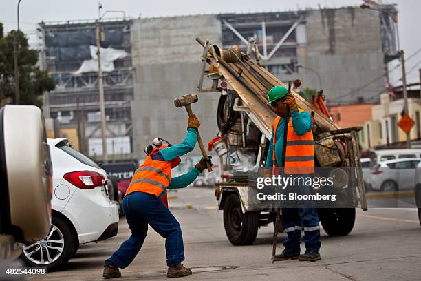 Worker swings a sledgehammer at the construction site of the Banco de la Nacion state bank headquarters building in the San Borja neighborhood of...