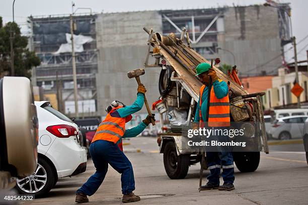 Worker swings a sledgehammer at the construction site of the Banco de la Nacion state bank headquarters building in the San Borja neighborhood of...