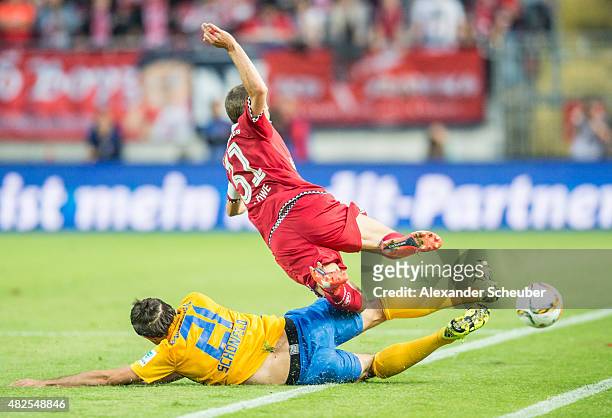 Patrick Schoenfeld challenges Chris LOEWE during the 2. Bundesliga match between 1. FC Kaiserslautern and Eintracht Braunschweig at...