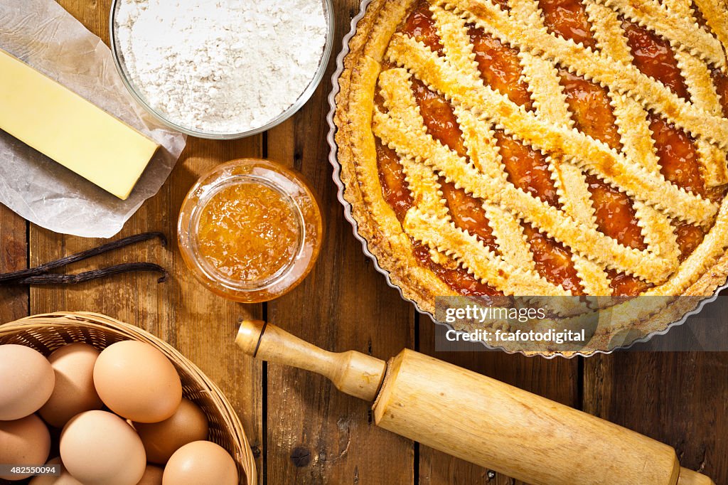 Homemade italian crostata with ingredients shot directly above