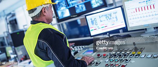 panoramic shot of technician in control room - kontrollrum bildbanksfoton och bilder