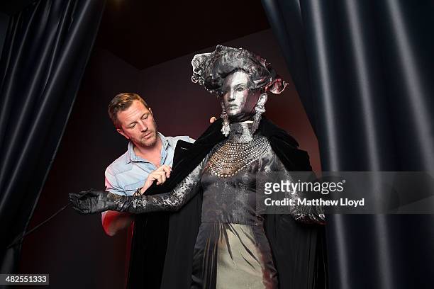 Exhibition Curator Thierry-Maxime Loriot makes final preparations to Jean Paul Gaultier couture at the Barbican Centre on April 3, 2014 in London,...