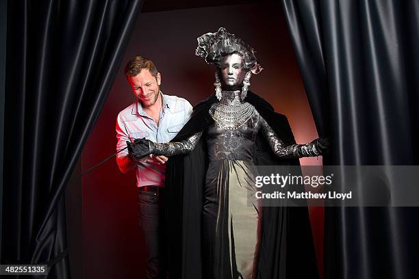 Exhibition Curator Thierry-Maxime Loriot makes final preparations to Jean Paul Gaultier couture at the Barbican Centre on April 3, 2014 in London,...