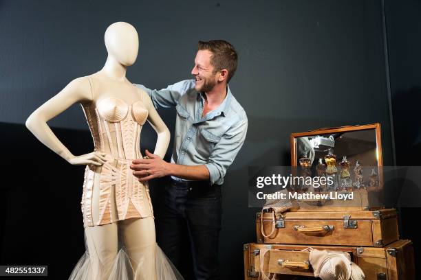 Exhibition Curator Thierry-Maxime Loriot makes final preparations to Jean Paul Gaultier couture at the Barbican Centre on April 3, 2014 in London,...