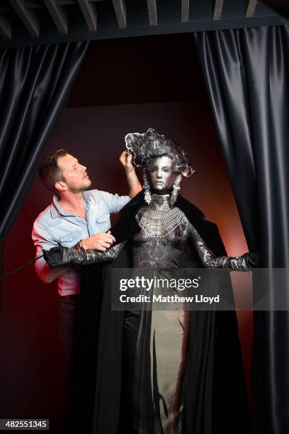 Exhibition Curator Thierry-Maxime Loriot makes final preparations to Jean Paul Gaultier couture at the Barbican Centre on April 3, 2014 in London,...