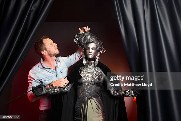 Exhibition Curator Thierry-Maxime Loriot makes final preparations to Jean Paul Gaultier couture at the Barbican Centre on April 3, 2014 in London,...