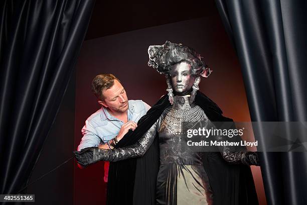 Exhibition Curator Thierry-Maxime Loriot makes final preparations to Jean Paul Gaultier couture at the Barbican Centre on April 3, 2014 in London,...